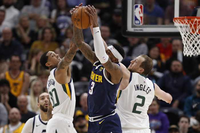 Jordan Clarkson (00) and Joe Ingles (2) fight for possession against the Denver Nuggets